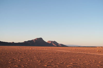 Scenic view of desert against clear sky