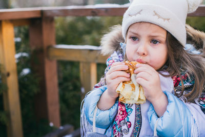 Portrait of cute girl holding ice cream cone outdoors