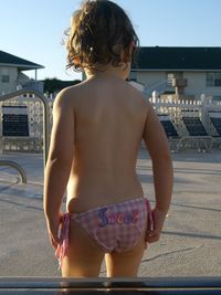 Rear view of baby girl standing at tourist resort