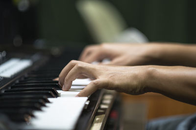 Midsection of woman playing piano