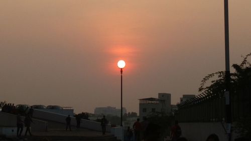 People on street at sunset