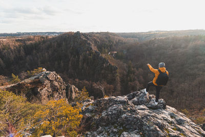 Rear view of man standing on rock