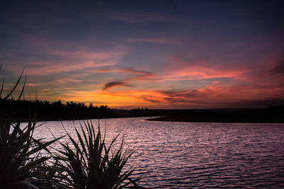 Scenic view of lake against romantic sky at sunset