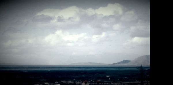 Scenic view of landscape by sea against sky