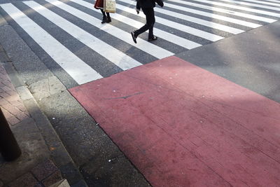 Low section of people walking on road