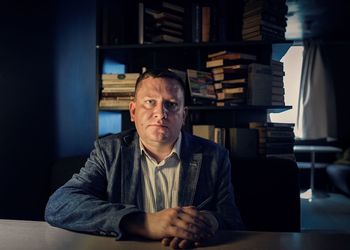 Portrait of businessman sitting at desk in office