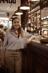 Portrait of young woman standing in store
