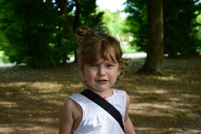 Portrait of girl standing on field