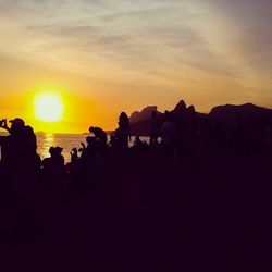 People photographing at sunset