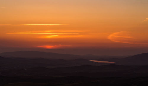 Scenic view of dramatic sky over landscape during sunset