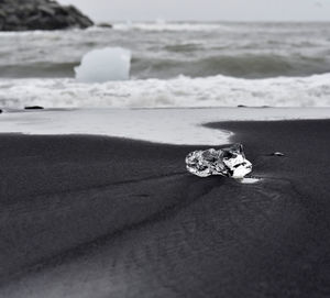 Surface level of sand on beach against sea