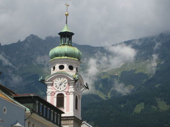 Low angle view of building and mountains against sky