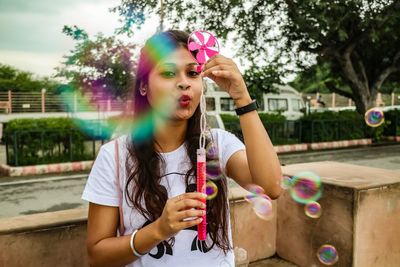 Happy girl holding bubbles