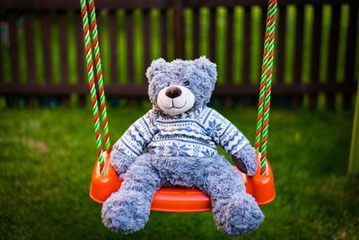 Close-up of toy on swing in playground