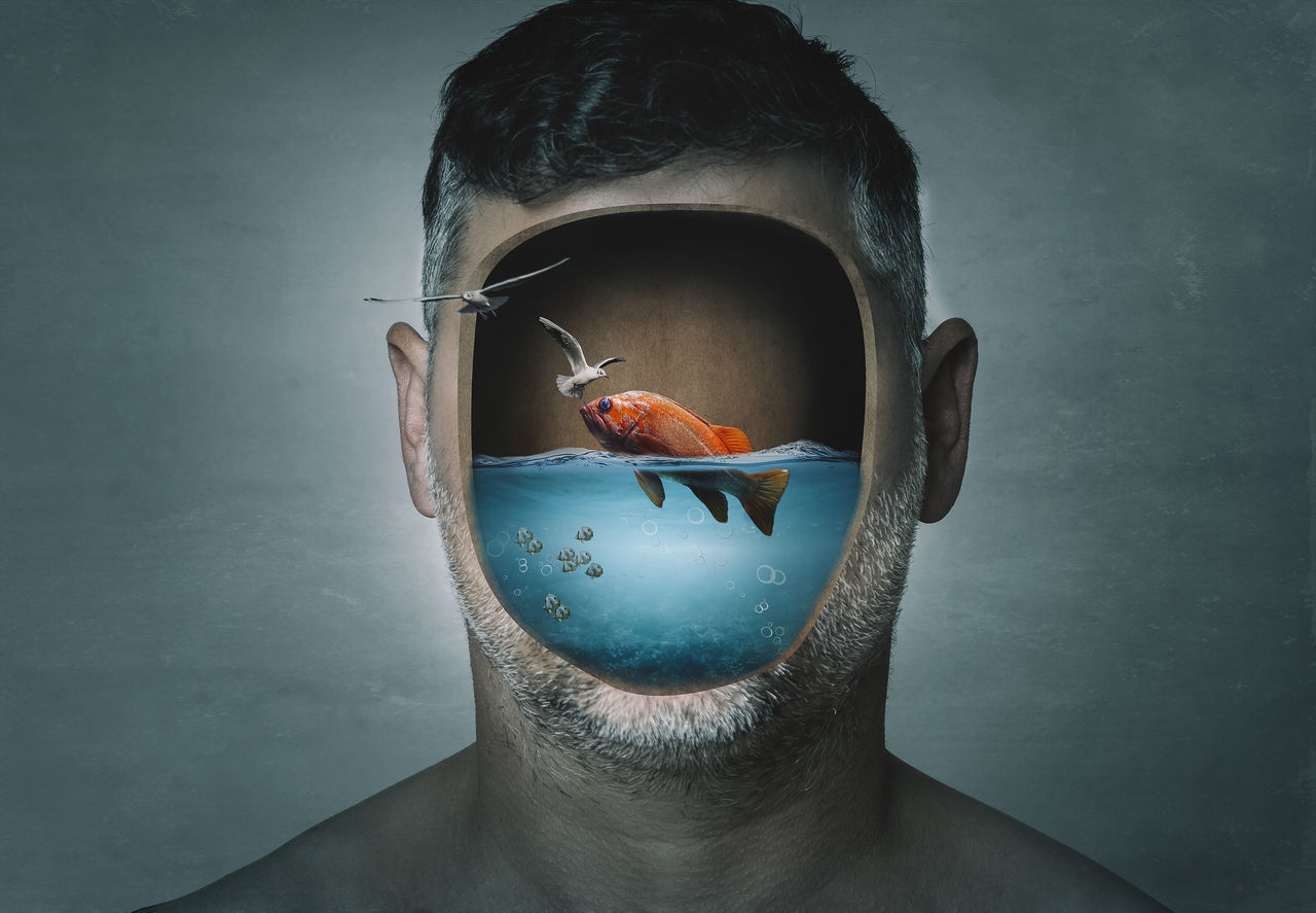 DIGITAL COMPOSITE IMAGE OF MAN WITH FISH