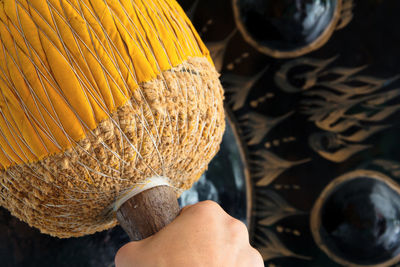 Cropped hand of person holding gong hammer