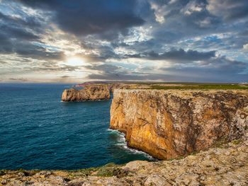 Scenic view of rocks in sea against sky