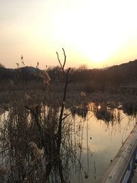 Scenic view of lake against sky during sunset