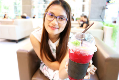 Portrait of smiling woman holding ice cream