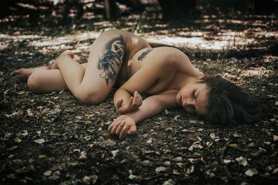 Young woman lying on ground