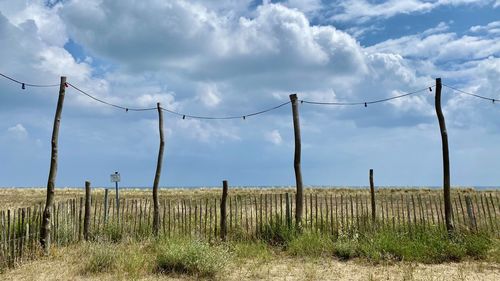 Fence on field against sky