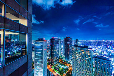 High angle view of illuminated buildings in city at night