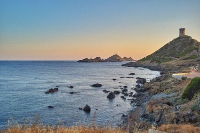 Scenic view of sea against clear sky at sunset