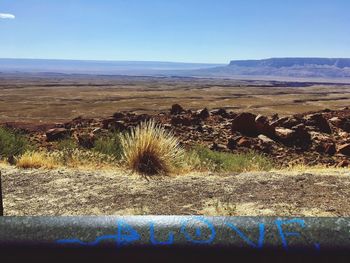 Scenic view of desert against blue sky