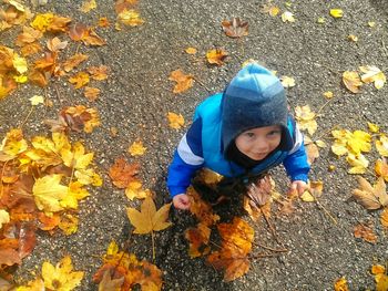 High angle view of boy playing on field during autumn