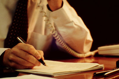 Close-up of man working at desk