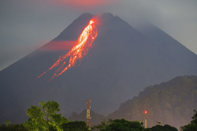 Smoke emitting from volcanic mountain against sky