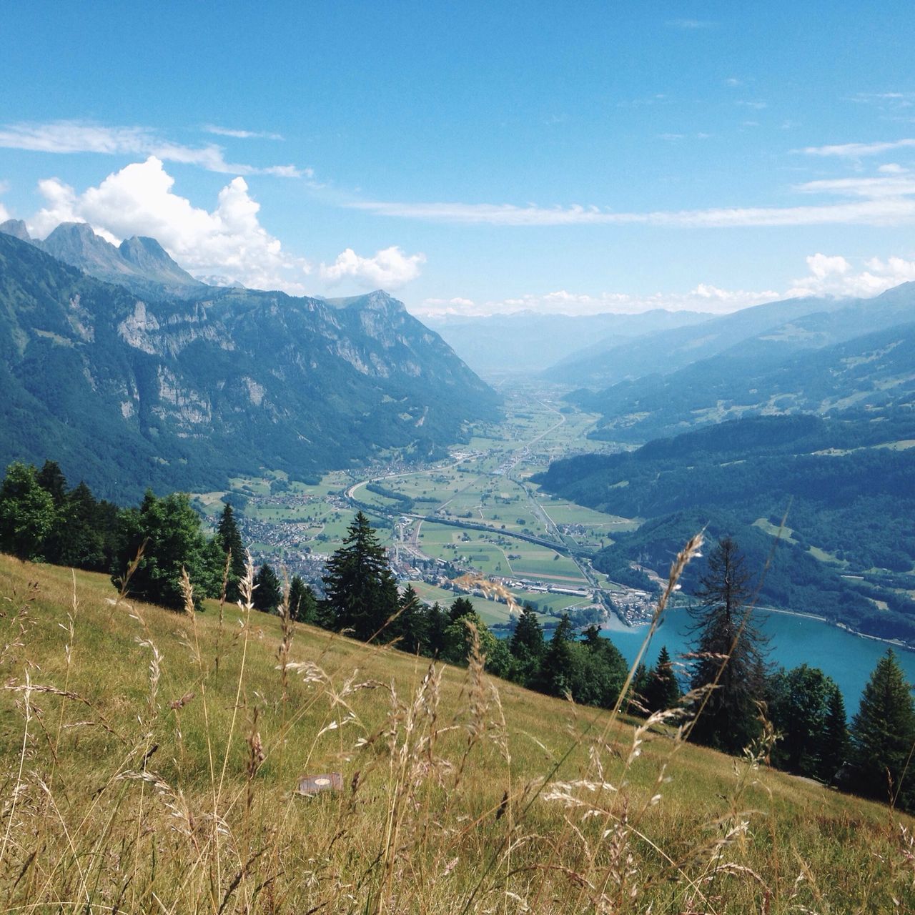 mountain, mountain range, sky, landscape, tranquil scene, scenics, tranquility, beauty in nature, nature, built structure, building exterior, architecture, cloud, cloud - sky, high angle view, blue, non-urban scene, day, hill, outdoors