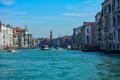 Boats in sea against buildings in city