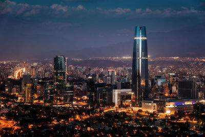 Illuminated buildings in city against sky