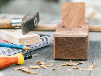 Close-up of book and work tools on table