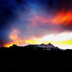 Scenic view of mountains against cloudy sky