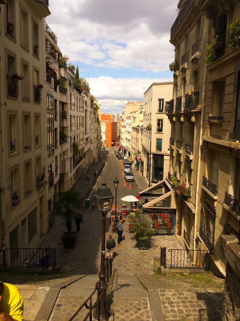 building exterior, architecture, built structure, sky, the way forward, residential structure, residential building, street, house, city, cloud - sky, residential district, town, cloud, building, narrow, diminishing perspective, cloudy, outdoors, incidental people