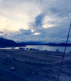 View of beach against cloudy sky