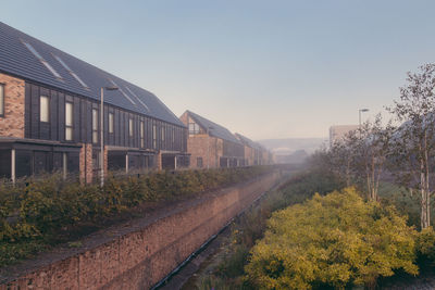 View of railroad track amidst buildings against clear sky