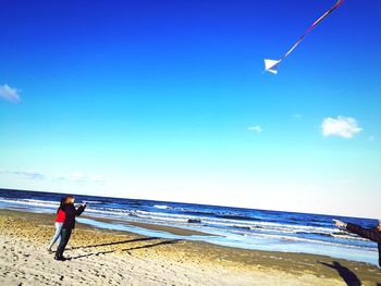 Man standing on beach against sky