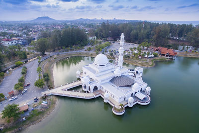 High angle view of tengku tengah zaharah mosque in lake against sky