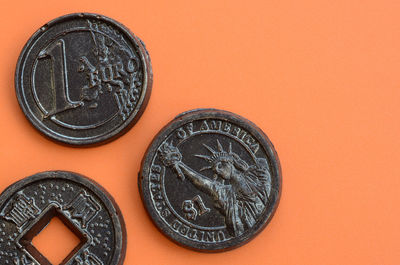 Close-up of coins on orange background