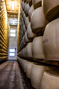 Stack of parmesan cheese wheels in a warehouse 
