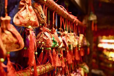 Close-up of decorations hanging for sale in market