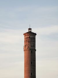 Lighthouse by sea against sky