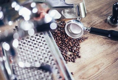 Close-up of machinery with coffee beans on table