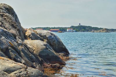 Rock formations by sea against sky