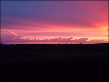 Scenic view of landscape against sky at sunset