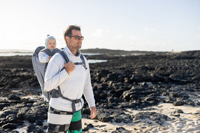 Portrait of man standing at beach