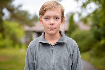 Portrait of boy standing outdoors